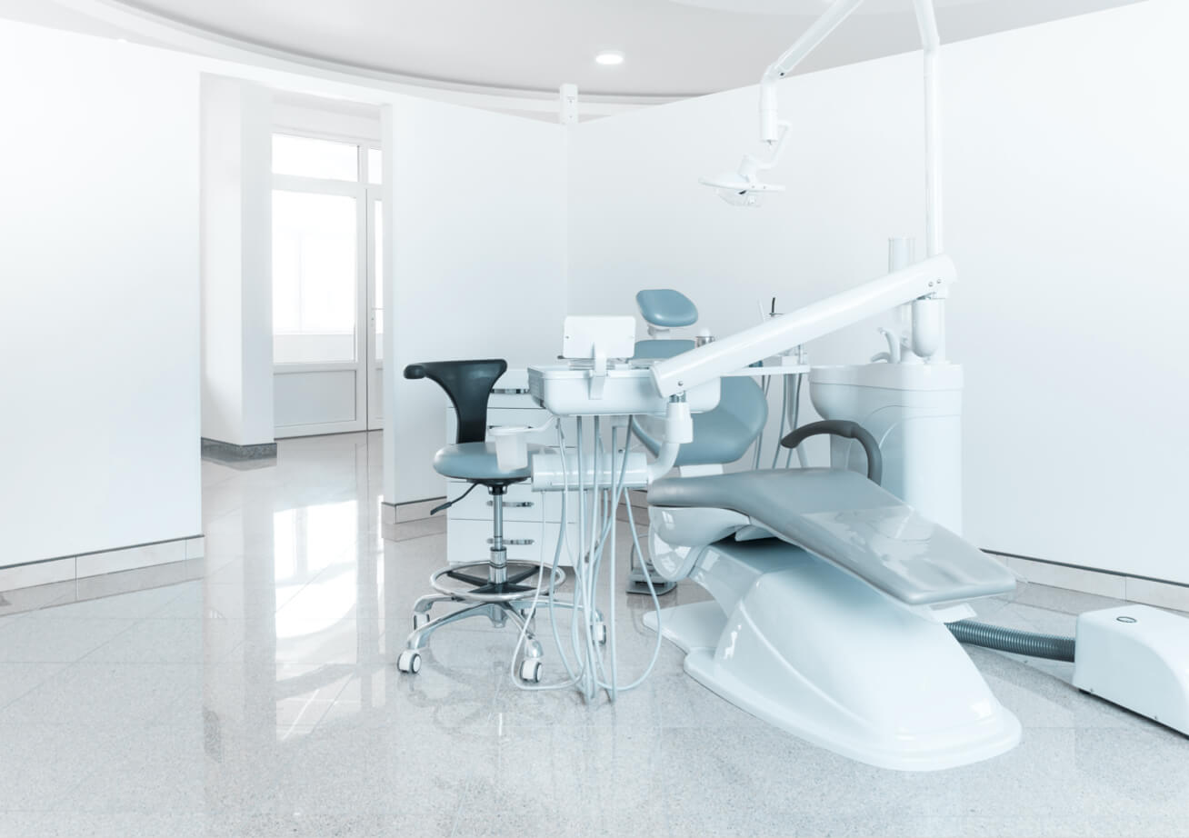 An empty patient room of a dental office