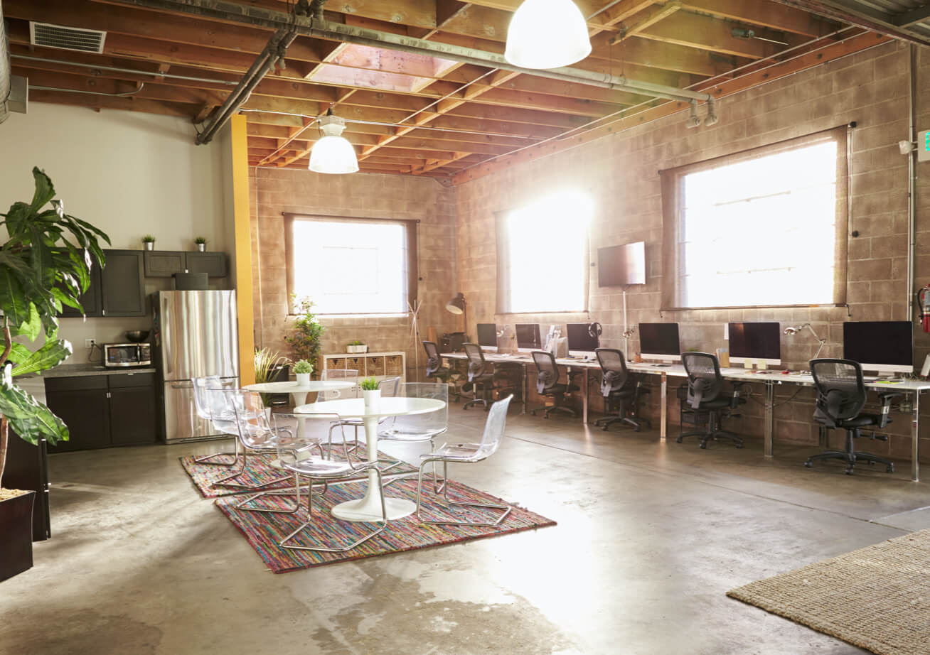 A bright naturally lit rustic interior of a startup office