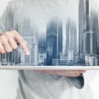 An abstract image of a city skyline in the palm of a man's hand