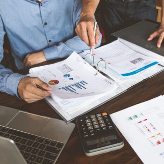 A man explain statistical data on paper to a client