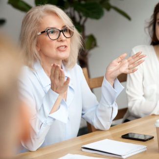 A woman negotiates a lease a a meeting table