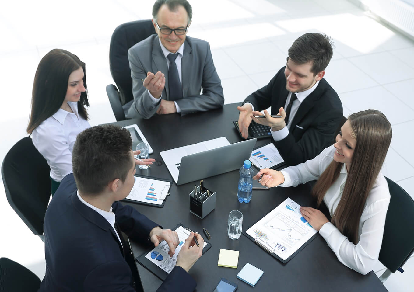 a group of realtors and clients renegotiate a lease at a meeting table