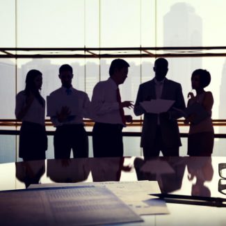 The silhouettes of business workers with a background view of the city skyline