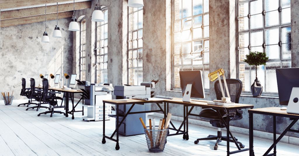 Modern office space with large windows and industrial design.