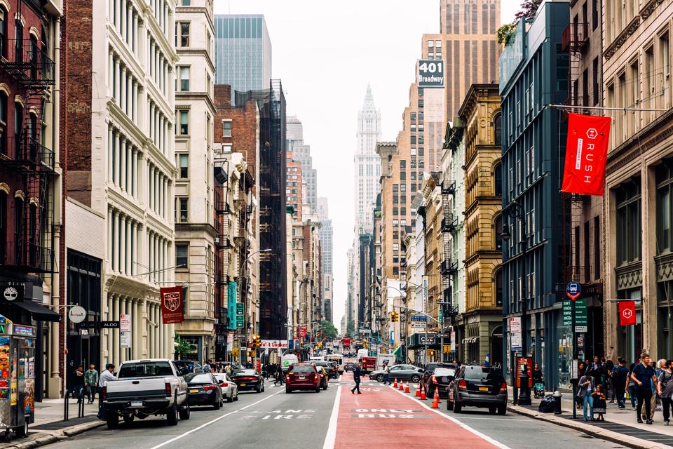 Busy city street lined with tall buildings and traffic. Busy city street lined with tall buildings and traffic.