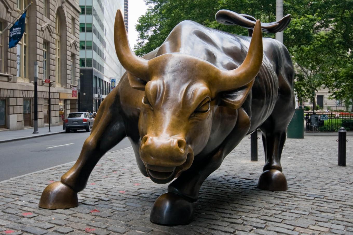 Charging Bull statue on a city street symbolizing financial optimism. Charging Bull statue on a city street symbolizing financial optimism.