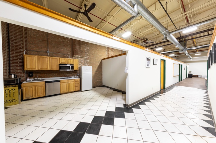 Kitchen with full-height cabinets, dishwasher and a checkerboard tile floor