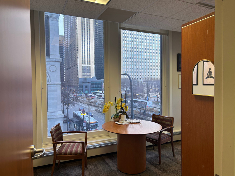 Consult room with a round table for two, looking out over Michigan Avenue
