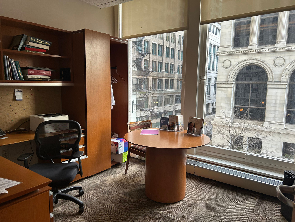 Physician's office with built-in shelving, reference books and a round consultation table