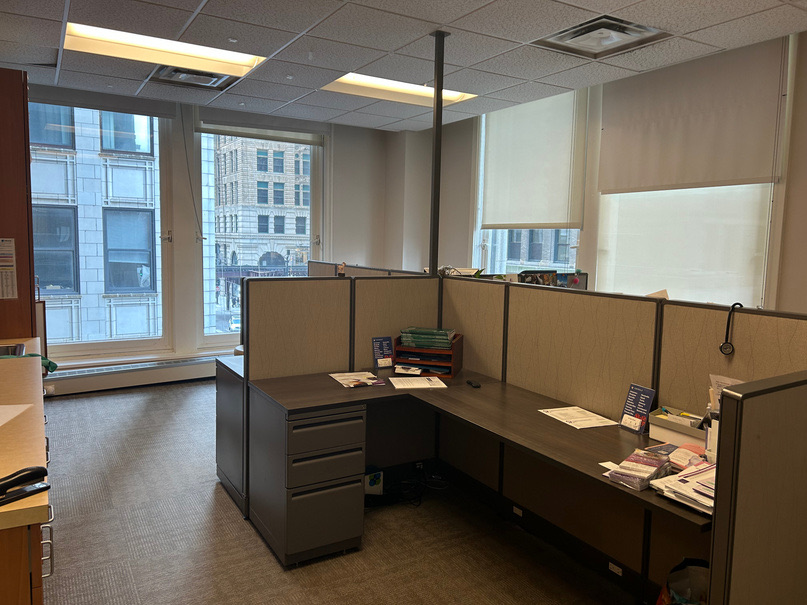 Staff workstations in cubicles along the windows over Michigan Avenue